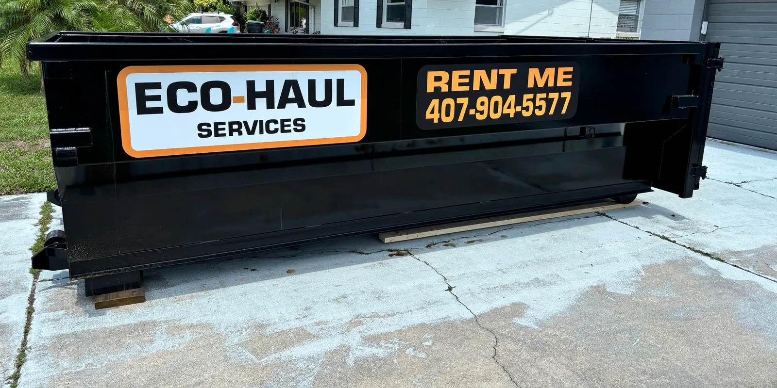 Eco Haul 14 yard roll off dumpster on a driveway in front of the customer's house